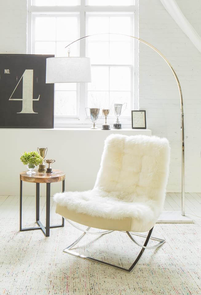 Furry white chair in a bright, well-decorated room