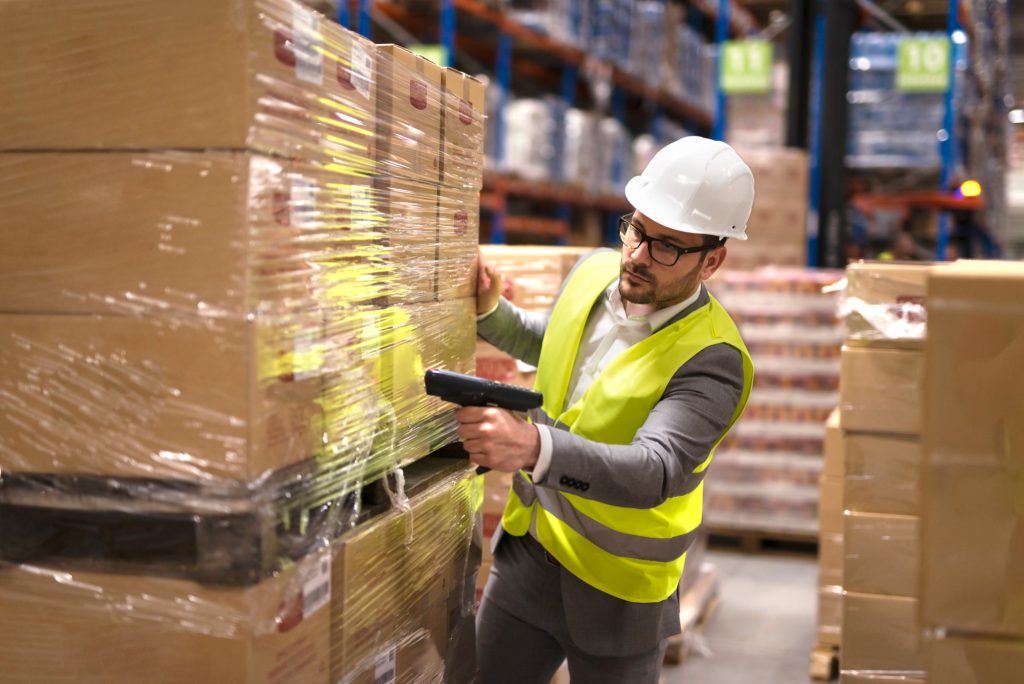 Worker in Warehouse Barcode Scanning Inventory