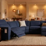 Navy blue power reclining sectional sofa with chaise in a modern living room setting